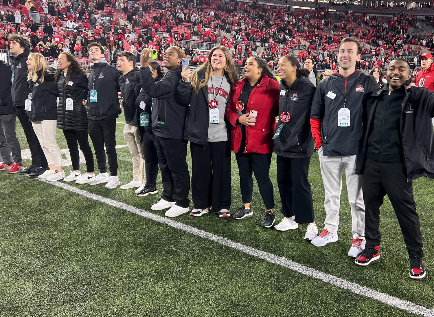 Hosts on the field after a football game